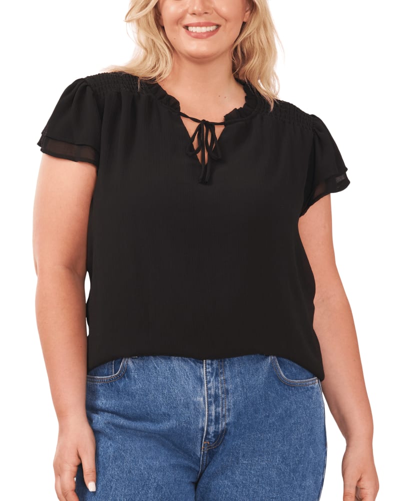 Front of a model wearing a size 1X Kiara Smocked Blouse in RICH BLACK by CeCe. | dia_product_style_image_id:263420
